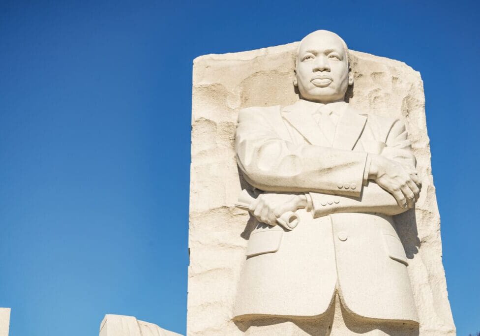 Statue of Martin Luther King Jr. against blue sky.